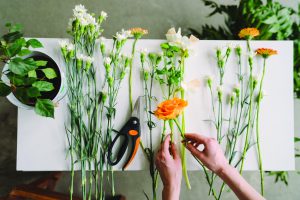 Florist workspace: caucasian woman making floral decorations