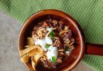 closeup of elk and venison chili in brown bowl