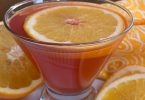 Closeup of a mocktail cosmo with an orange slice