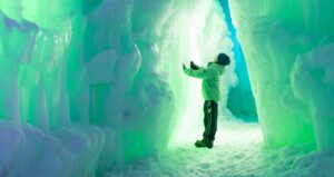 Child in front of Ice Castles