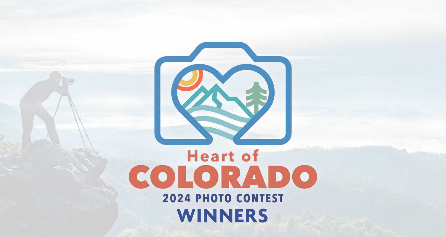 Logo for "Heart of Colorado 2024 Photo Contest Winners" showing a mountain scene within a camera shape. Photographer stands on a rocky cliff, capturing the view.