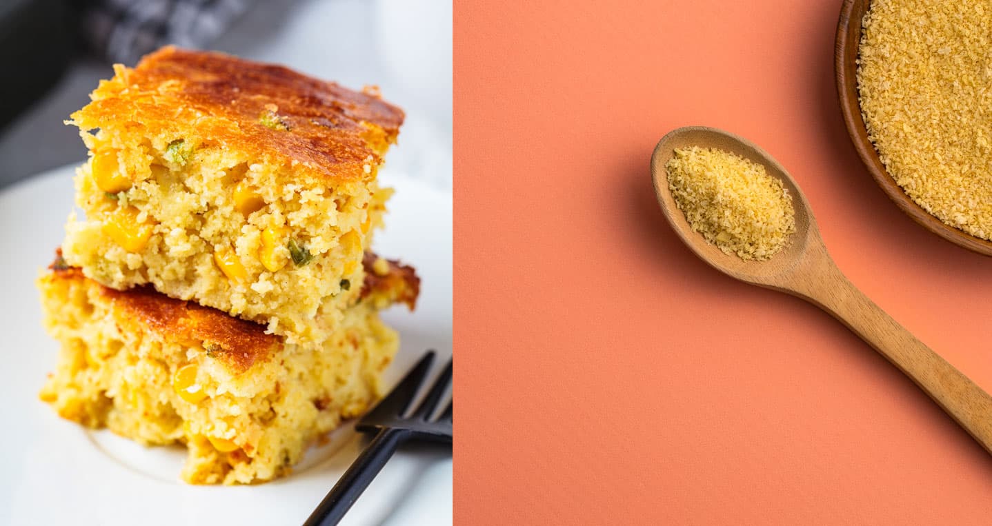 Two slices of cornbread stacked on a plate with a fork, next to a wooden spoon and bowl containing cornmeal on an orange surface.