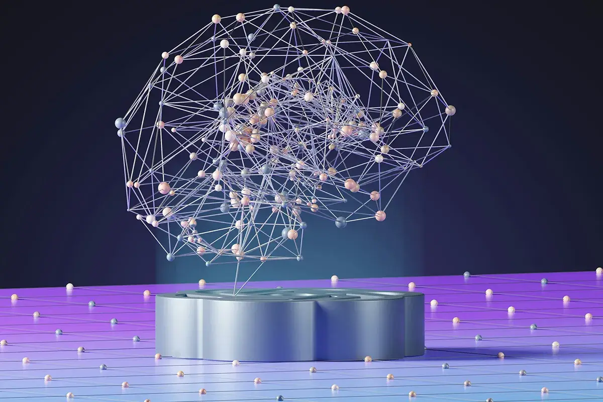 A digital rendering of a brain-shaped structure made of interconnected lines and spheres on a circular podium, with scattered spheres on a purple surface.