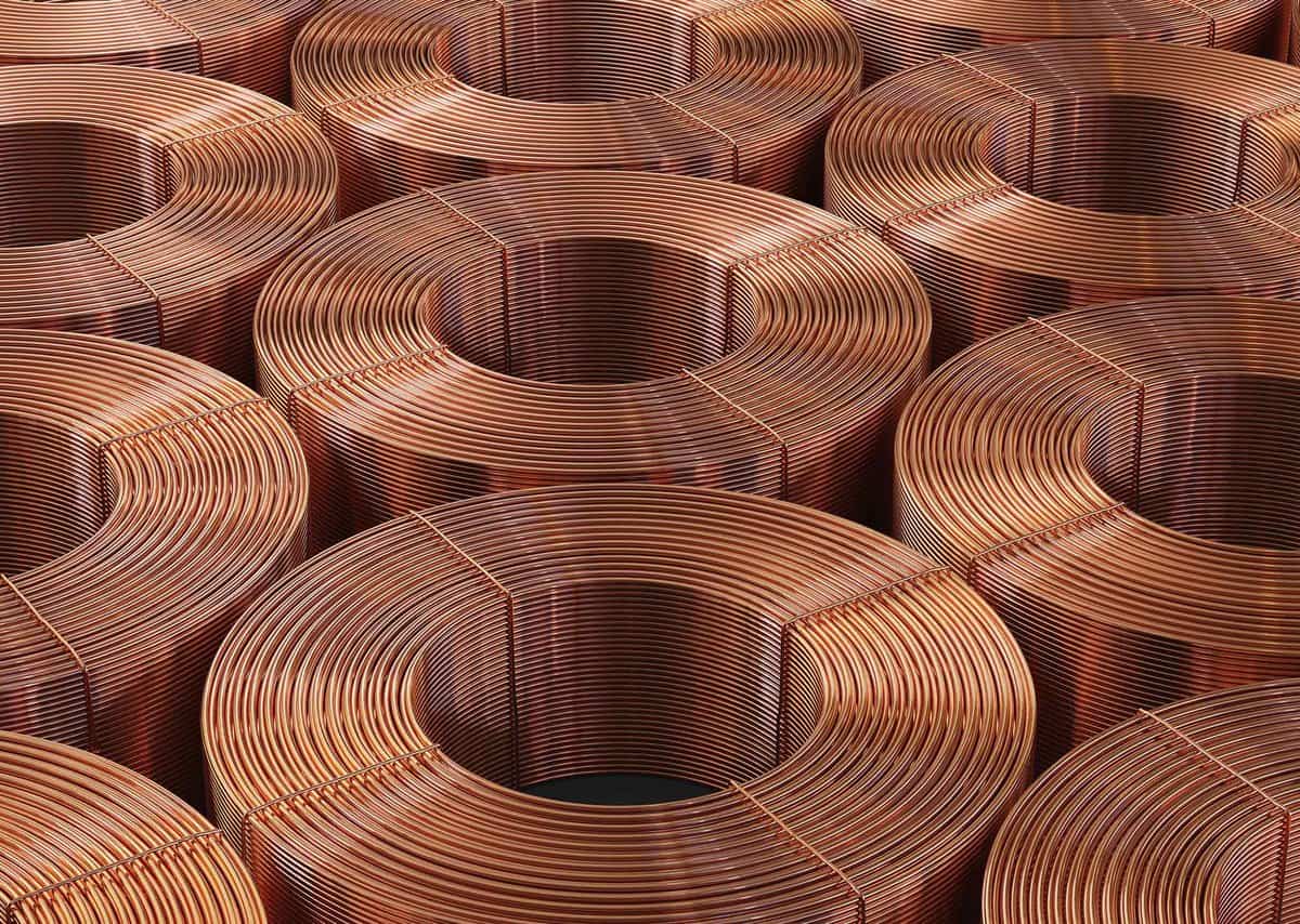 Several neatly stacked coils of copper wire arranged in a grid pattern.